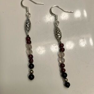 Garnet and rose quartz with silver accents on silver oval hangers earrings.